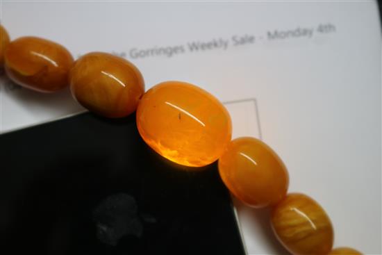 A single strand graduated oval amber bead necklace, gross weight 69 grams, 70cm.